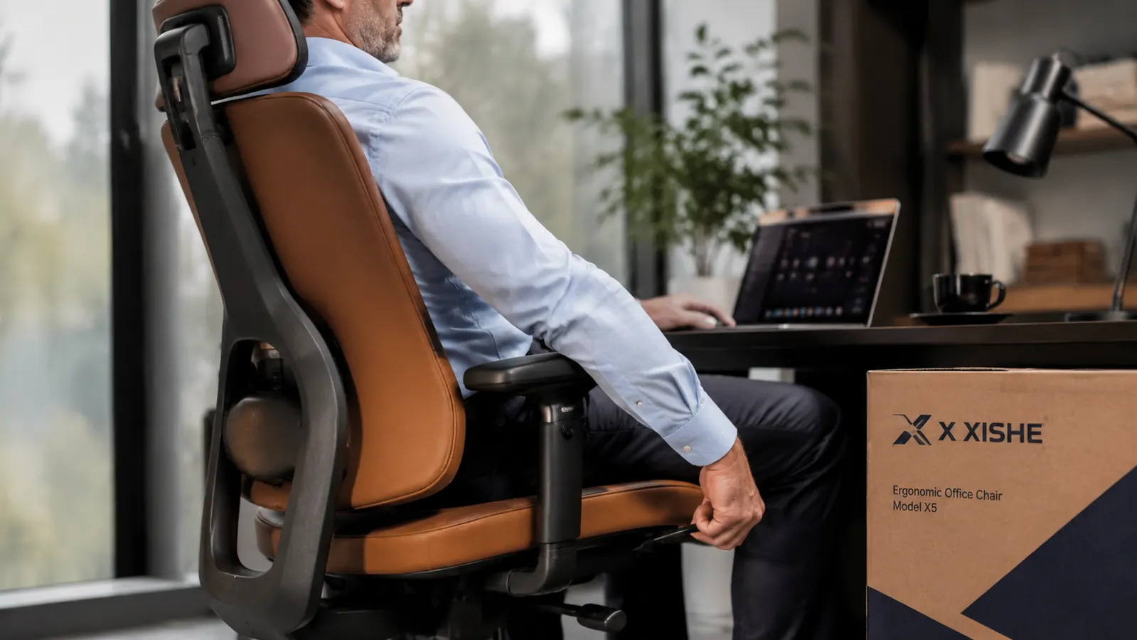 Person sitting in ergonomic office chair adjusting the armrest height while seated at a desk